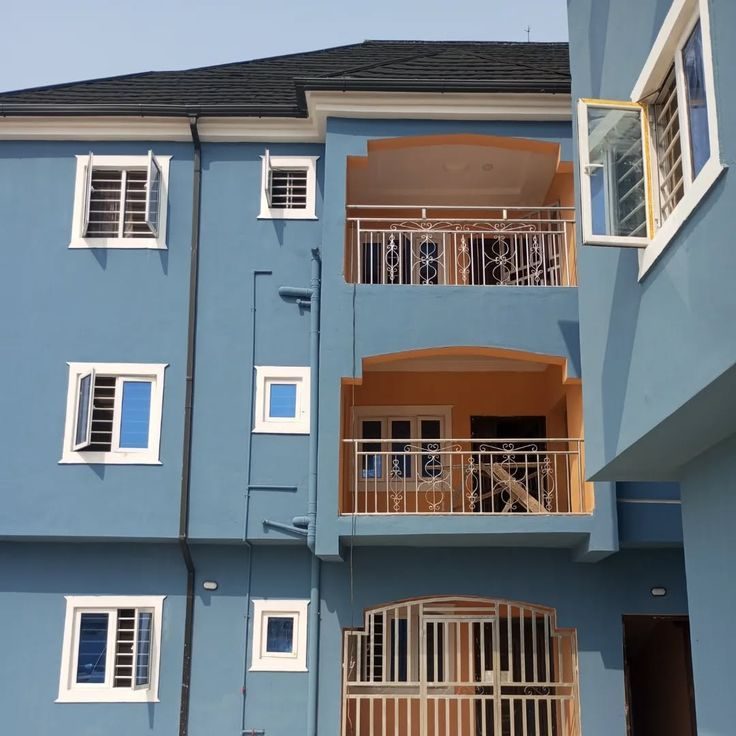Three-storey block, blue and terracotta, Lagos