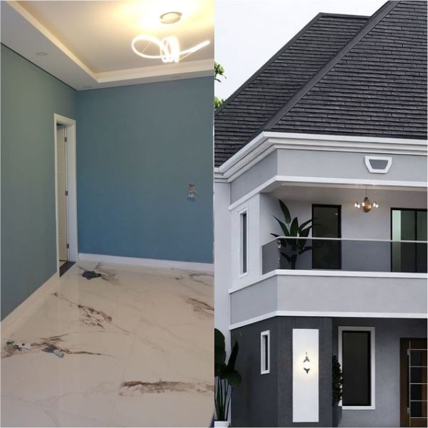 Nigerian painter decorating interior wall